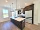 Modern kitchen with island and stainless steel appliances at 4802 Larkin Pass, Buford, GA 30518