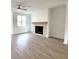 Living room featuring a modern fireplace and hardwood floors at 4802 Larkin Pass, Buford, GA 30518