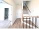 Light oak staircase with black metal railing and hardwood floors at 4802 Larkin Pass, Buford, GA 30518