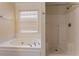 Bathroom with shower and whirlpool tub at 2216 Mcdaniel Mill Sw Rd, Conyers, GA 30094