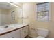 Clean bathroom with a vanity, toilet and shower/tub combo at 2216 Mcdaniel Mill Sw Rd, Conyers, GA 30094