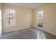 Well-lit bedroom with carpet flooring and two windows at 2216 Mcdaniel Mill Sw Rd, Conyers, GA 30094