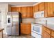 Kitchen with stainless steel appliances and oak cabinets at 2216 Mcdaniel Mill Sw Rd, Conyers, GA 30094