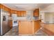 Kitchen with oak cabinets and stainless steel appliances at 2216 Mcdaniel Mill Sw Rd, Conyers, GA 30094