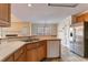 Kitchen with island, stainless steel appliances and oak cabinets at 2216 Mcdaniel Mill Sw Rd, Conyers, GA 30094