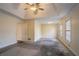 Large main bedroom with tray ceiling, ceiling fan, and multiple windows at 2216 Mcdaniel Mill Sw Rd, Conyers, GA 30094