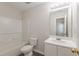 Clean bathroom with tub, shower, toilet, and vanity at 320 Goldenrod Dr, Stockbridge, GA 30281