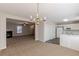 Dining area with chandelier and view into living room at 320 Goldenrod Dr, Stockbridge, GA 30281