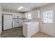 Kitchen with white cabinets, appliances, and vinyl flooring at 320 Goldenrod Dr, Stockbridge, GA 30281