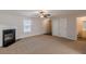 Spacious living room with fireplace, carpet, and neutral walls at 320 Goldenrod Dr, Stockbridge, GA 30281