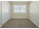 Well-lit bedroom with neutral walls, carpeting, and double closet at 3488 Brookfield Ln, Decatur, GA 30032