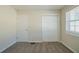 Bedroom with neutral walls, carpeting, and a closet and door at 3488 Brookfield Ln, Decatur, GA 30032