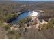 Aerial view showing a large pond surrounded by trees at 910 Callee Dr, Loganville, GA 30052