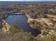 Aerial view of a property featuring two tranquil lakes and surrounding woodlands at 910 Callee Dr, Loganville, GA 30052