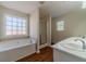 Bathroom featuring a large garden tub and separate shower at 910 Callee Dr, Loganville, GA 30052