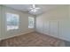 Well-lit bedroom with carpet, ceiling fan and wainscoting at 910 Callee Dr, Loganville, GA 30052