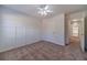 Spacious bedroom with carpet, ceiling fan and access to hallway at 910 Callee Dr, Loganville, GA 30052