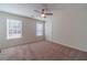 Well-lit bedroom featuring carpet and ceiling fan at 910 Callee Dr, Loganville, GA 30052