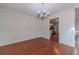 Bright dining room with hardwood floors, chandelier, and kitchen views at 910 Callee Dr, Loganville, GA 30052