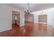 Open dining area with hardwood floors, chandelier, and kitchen access at 910 Callee Dr, Loganville, GA 30052