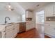 Modern kitchen with white cabinets, stainless steel appliances, and hardwood floors at 910 Callee Dr, Loganville, GA 30052