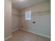 Laundry room with tile floor and shelving at 910 Callee Dr, Loganville, GA 30052