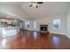 Open living room with hardwood floors, fireplace, and kitchen access at 910 Callee Dr, Loganville, GA 30052