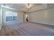 Spacious main bedroom with carpeted floors and tray ceiling at 910 Callee Dr, Loganville, GA 30052