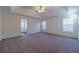 Spacious main bedroom with carpeted floors and tray ceiling at 910 Callee Dr, Loganville, GA 30052