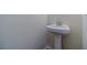 Convenient pedestal sink in a small half-bath at 910 Callee Dr, Loganville, GA 30052