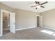 Large bedroom featuring a ceiling fan, carpeted floor, and neutral walls at 85 Woodfin Way, Social Circle, GA 30025