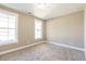 Bedroom with neutral carpet, off-white walls, and white trim with natural light at 85 Woodfin Way, Social Circle, GA 30025