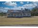 Charming ranch-style home featuring a welcoming front porch and well-maintained landscaping at 85 Woodfin Way, Social Circle, GA 30025