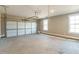 Spacious garage with windows and a white garage door ready to be put to use at 85 Woodfin Way, Social Circle, GA 30025