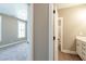 Hallway between rooms with gray carpet, off-white walls, and white trim at 85 Woodfin Way, Social Circle, GA 30025