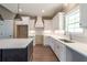 Modern kitchen featuring an island and white cabinets, designed for both style and functionality at 85 Woodfin Way, Social Circle, GA 30025