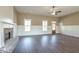 Spacious living room featuring a fireplace and beautiful wood floors, creating a cozy and inviting space at 85 Woodfin Way, Social Circle, GA 30025