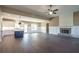 Bright living room with a fireplace, seamlessly connected to a kitchen featuring a large island at 85 Woodfin Way, Social Circle, GA 30025