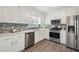 Modern kitchen with white cabinets and stainless steel appliances at 7470 Wynfield Dr, Cumming, GA 30040