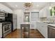 Modern kitchen with white cabinets, island, and hardwood floors at 2215 Edison Ne Ave, Atlanta, GA 30305