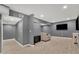 Finished basement with a large sectional sofa, TV, and hardwood flooring at 240 Pinebrook Way, Roswell, GA 30076