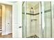 Modern shower with tiled walls, glass door, and built-in shelving at 3545 Fairway Dr, Atlanta, GA 30337