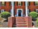 Classic brick stairs lead to a welcoming entrance with elegant landscaping at 3545 Fairway Dr, Atlanta, GA 30337