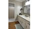 Bright bathroom with granite countertop, white cabinets, and access to a separate shower area at 747 Dogwood Cir, Norcross, GA 30071
