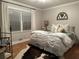Inviting bedroom with hardwood floors, a soft rug, and large window for ample natural light at 747 Dogwood Cir, Norcross, GA 30071