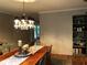 Elegant dining room with a chandelier, a long wooden table, and seating for six at 747 Dogwood Cir, Norcross, GA 30071