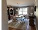 Comfortable dining room with hardwood floors, chandelier, built-in hutch, and brick wall at 747 Dogwood Cir, Norcross, GA 30071