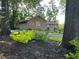 Home exterior features landscaping, a garage, driveway, and beautiful mature shade trees at 747 Dogwood Cir, Norcross, GA 30071