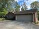 Ranch-style brick home with an attached two-car garage and mature trees at 747 Dogwood Cir, Norcross, GA 30071