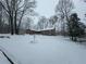 Charming brick home with a large front yard covered in a blanket of fresh snow at 747 Dogwood Cir, Norcross, GA 30071